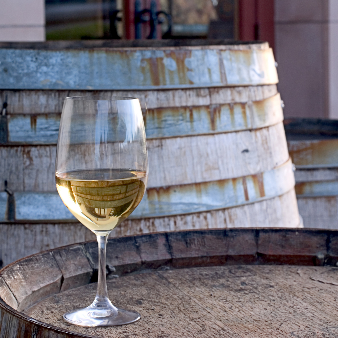 Glass of wine on wine barrel