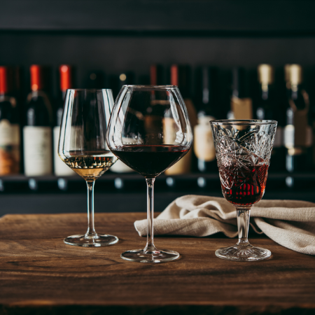 Red wine glass, white wine glass and special wine glass on a wooden table